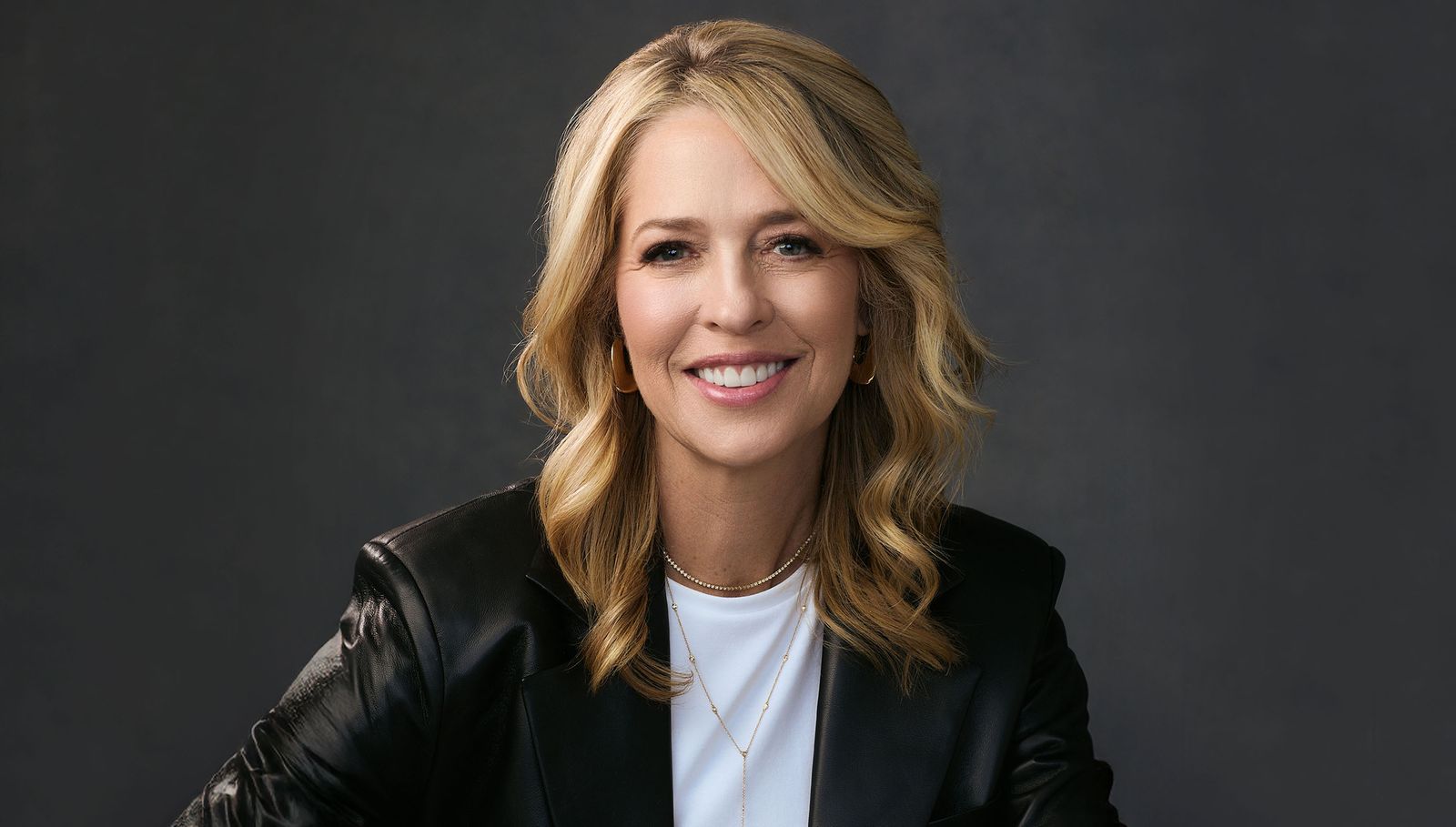 Image may contain Laurene Powell Jobs Blonde Hair Person Head Face Photography Portrait Happy and Smile