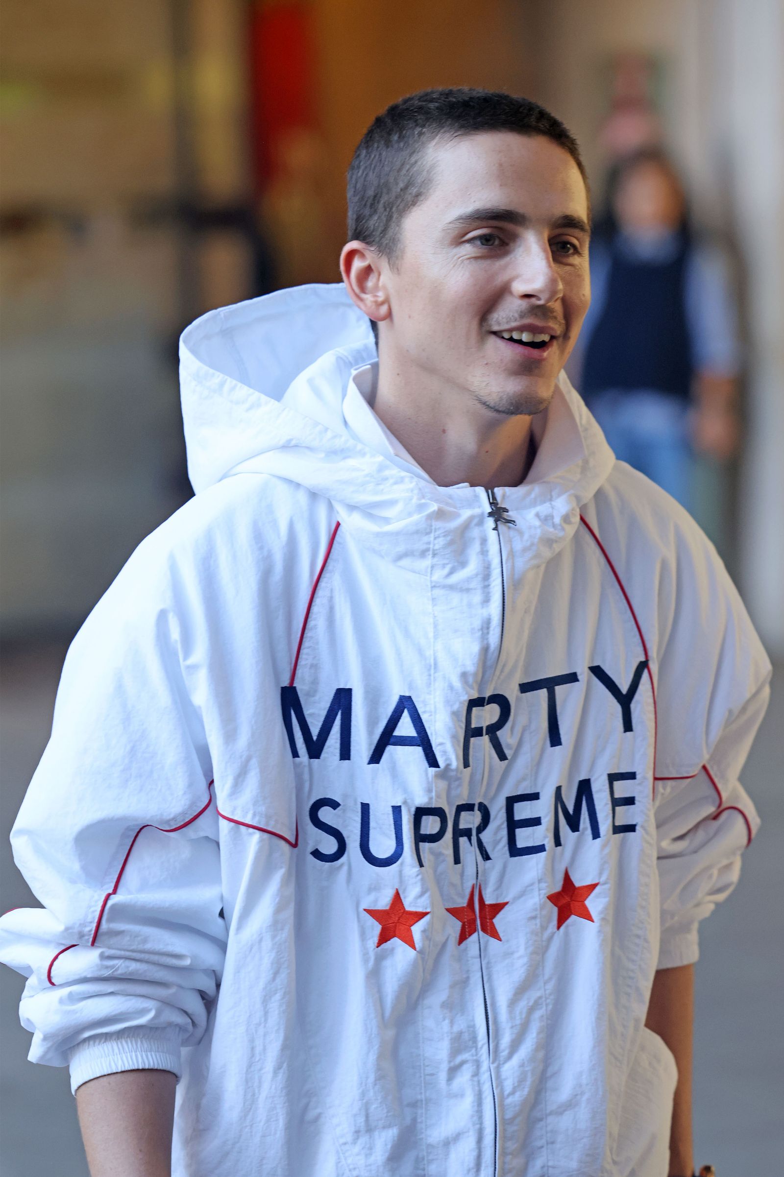 The image may contain the face and head of Timothe Chalamet Clothing Jacket Knitwear Sweater Sweatshirt T-Shirt Hoodie