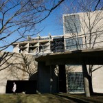 A blocky concrete building with a long ramp extending from the second floor.