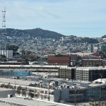 A building at the bottom of the mountain and other buildings on the mountain.