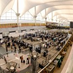Photo shows travelers queuing at security checkpoint at Denver International Airport in Denver, Colorado