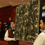 Tehran, Iran - June 28: The auctioneer and veiled assistants display a painting by an Iranian master during an auction at the restaurant of Azadi Hotel on June 28, 2013 in Tehran, Iran. (Photo by Kavi Kazemi/Getty Images)