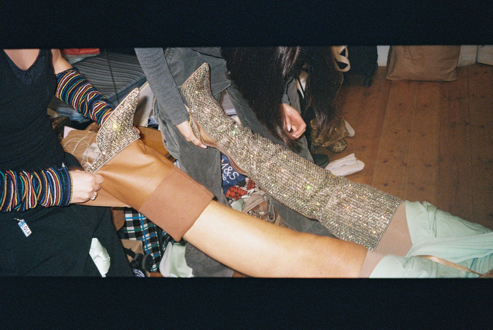 Image may contain clothing, footwear, shoes, adults, arms, body parts, accessories, bracelets, jewelry, socks and socks