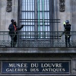 Two workers are installing grilles on the windows. They were standing on a balcony with a sign that said 