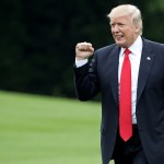 A man in a suit and red tie waved his right fist.