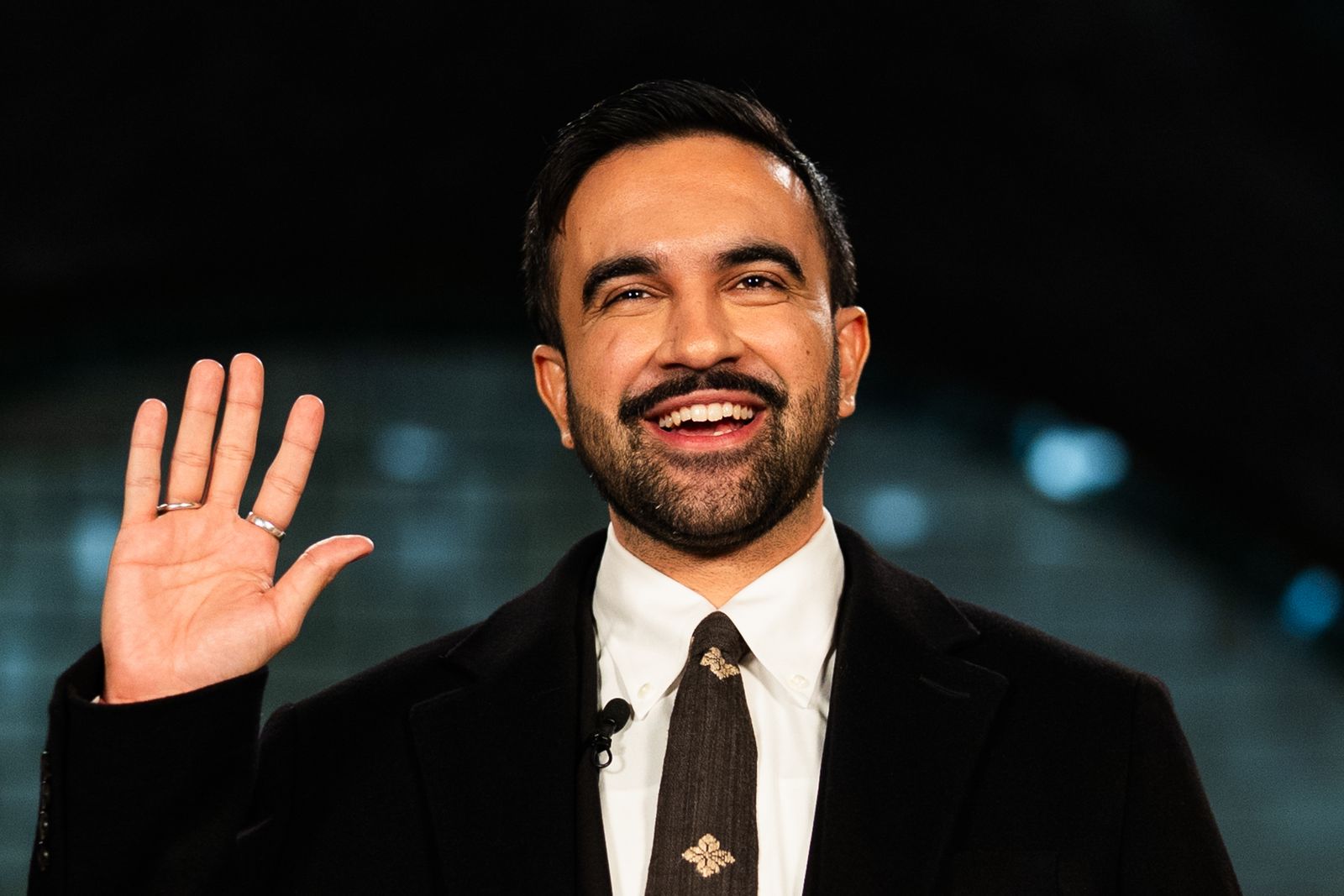 Image may contain profile picture, happy smile, dimples, adult clothing, coats, accessories, formal clothing and ties