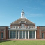 The exterior of an elegant British museum building in the park.