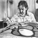 A man is painting with a paintbrush.