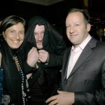 Three people pose for the camera.