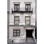 Exterior view of an all-white townhouse in New York.
