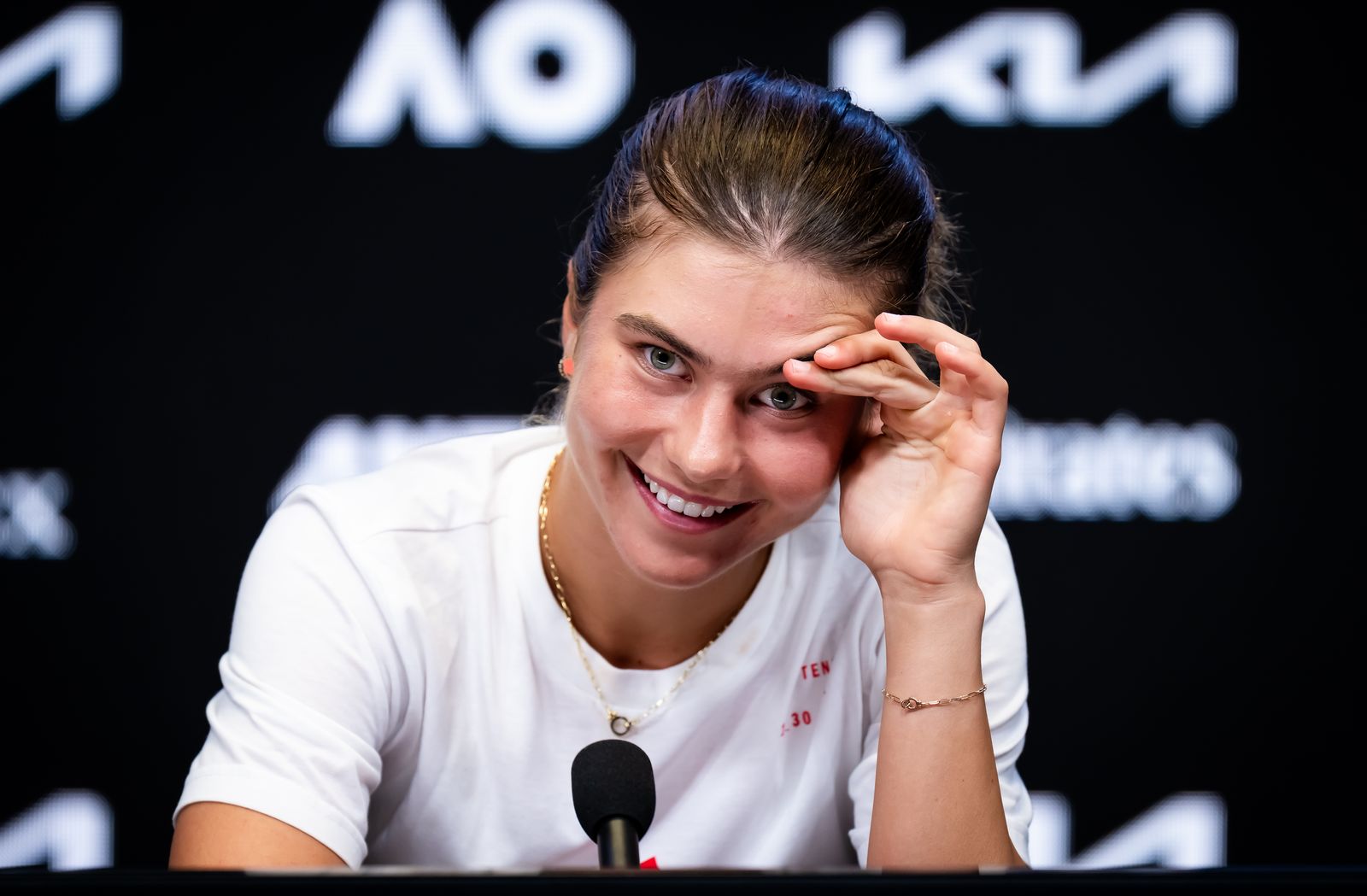 Image may contain Helen Kelesi face avatar person Happy Smile adult dimples electronic device and microphone