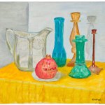 A still life of a cut pomegranate, a glass pitcher, and four different candlesticks on a yellow table cloth.