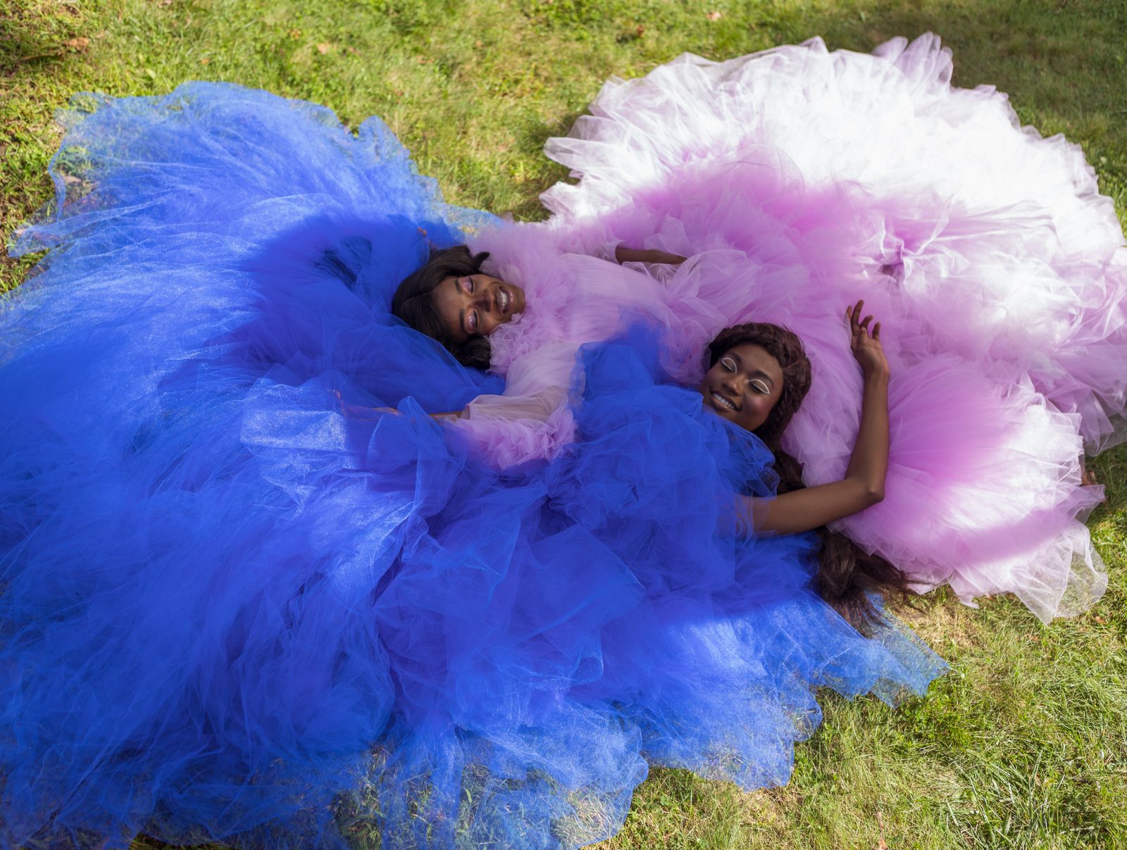 Image may contain face, head, people photography, portrait, grass, plant, purple clothing, clothing, clothing and nature
