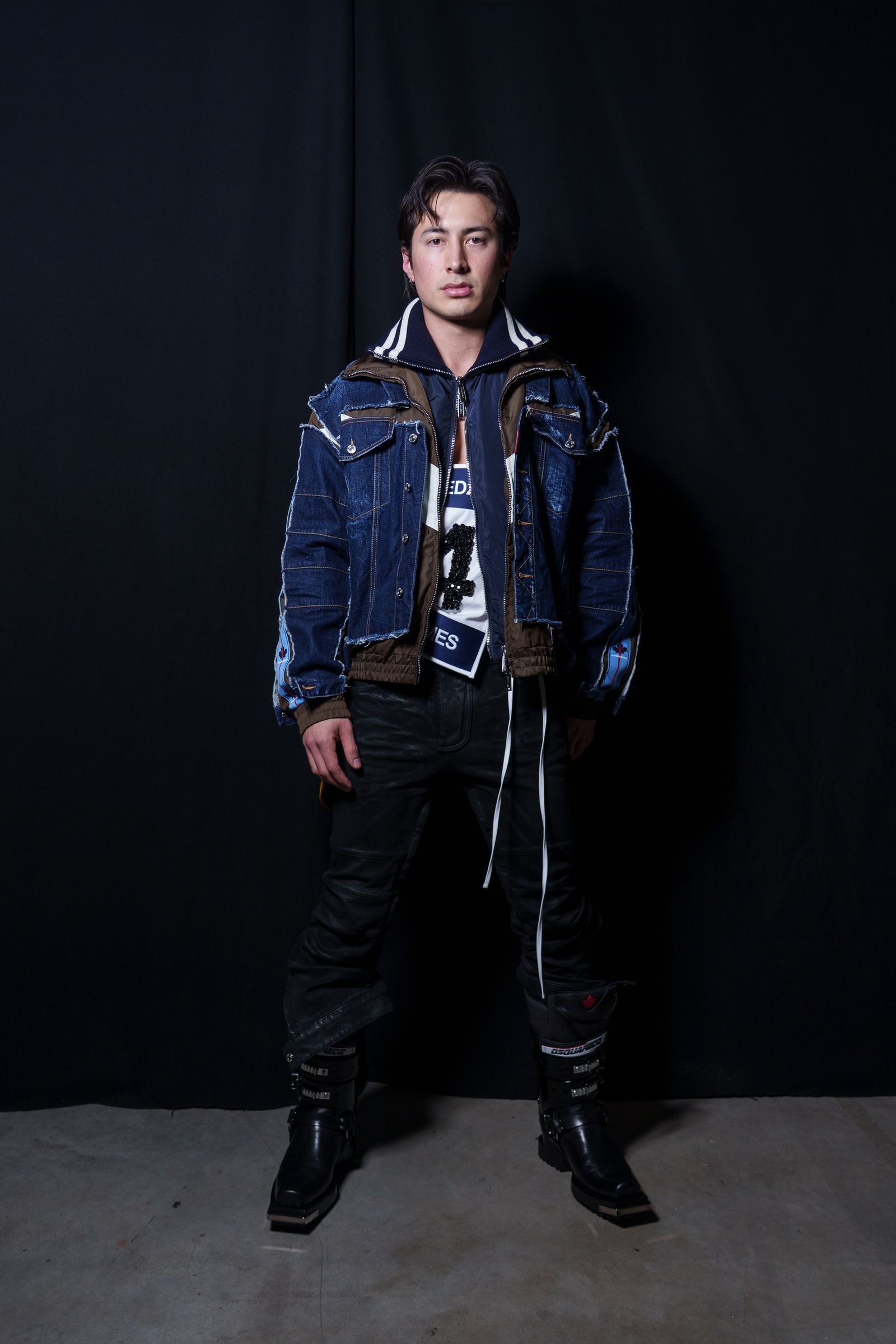 Image may contain Noah Gundersen clothing coat jacket pants adult vest jeans footwear shoes and standing