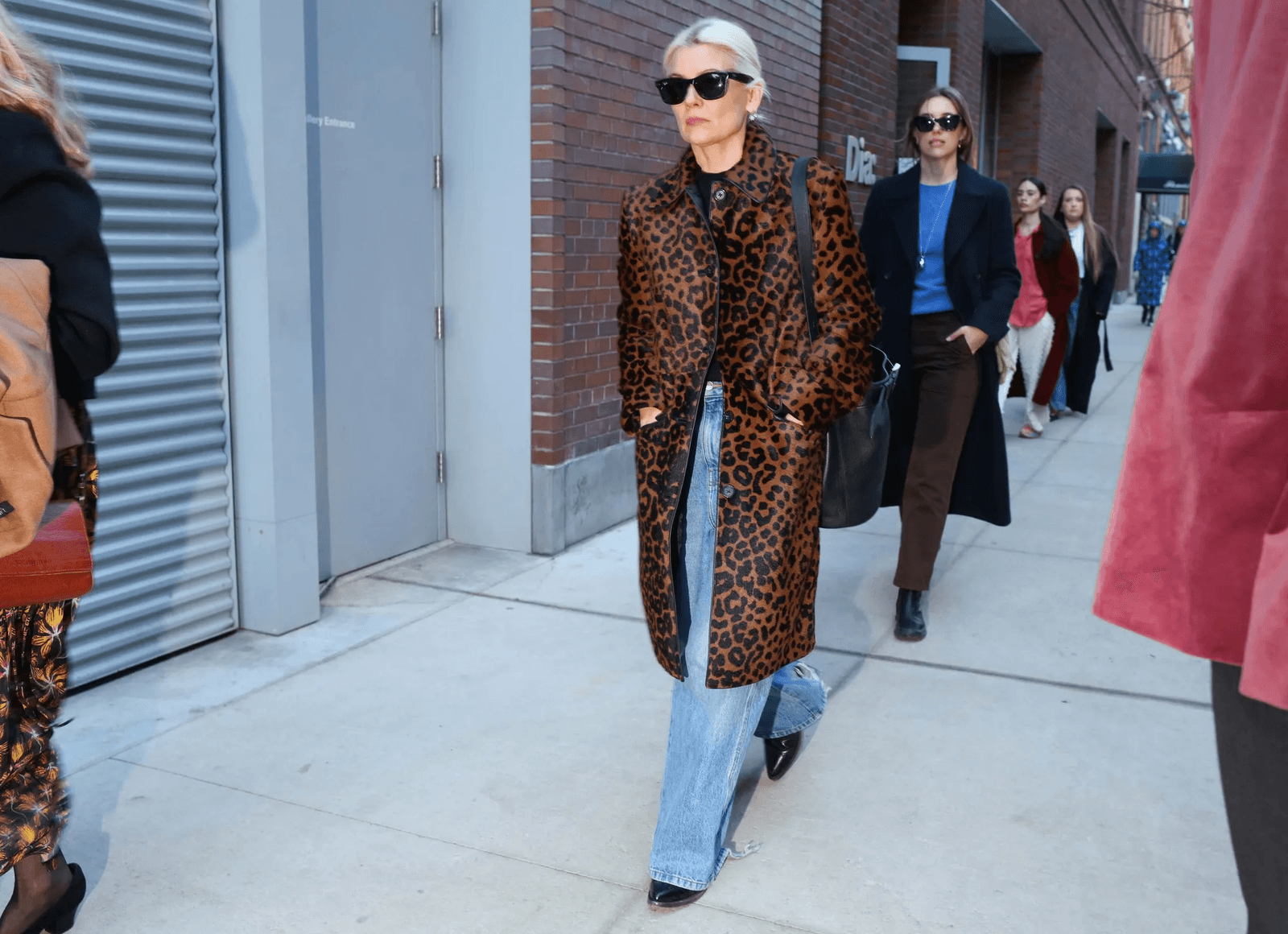 Image may contain clothing, coats, adult coats, formal wear and suits