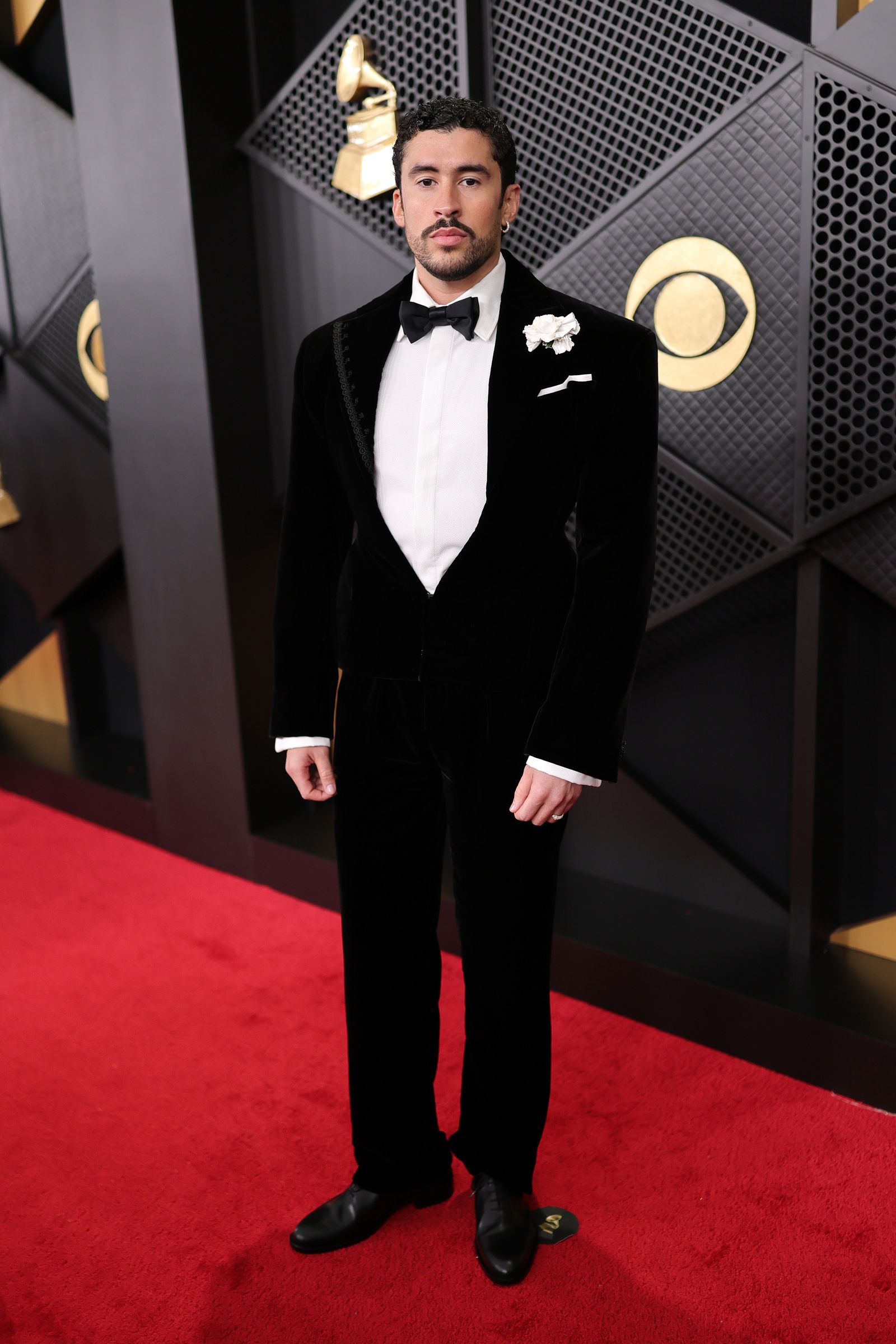 Image may contain Bad Bunny Clothing Formal Suit Tuxedo Adult Fashion Standing and Coat