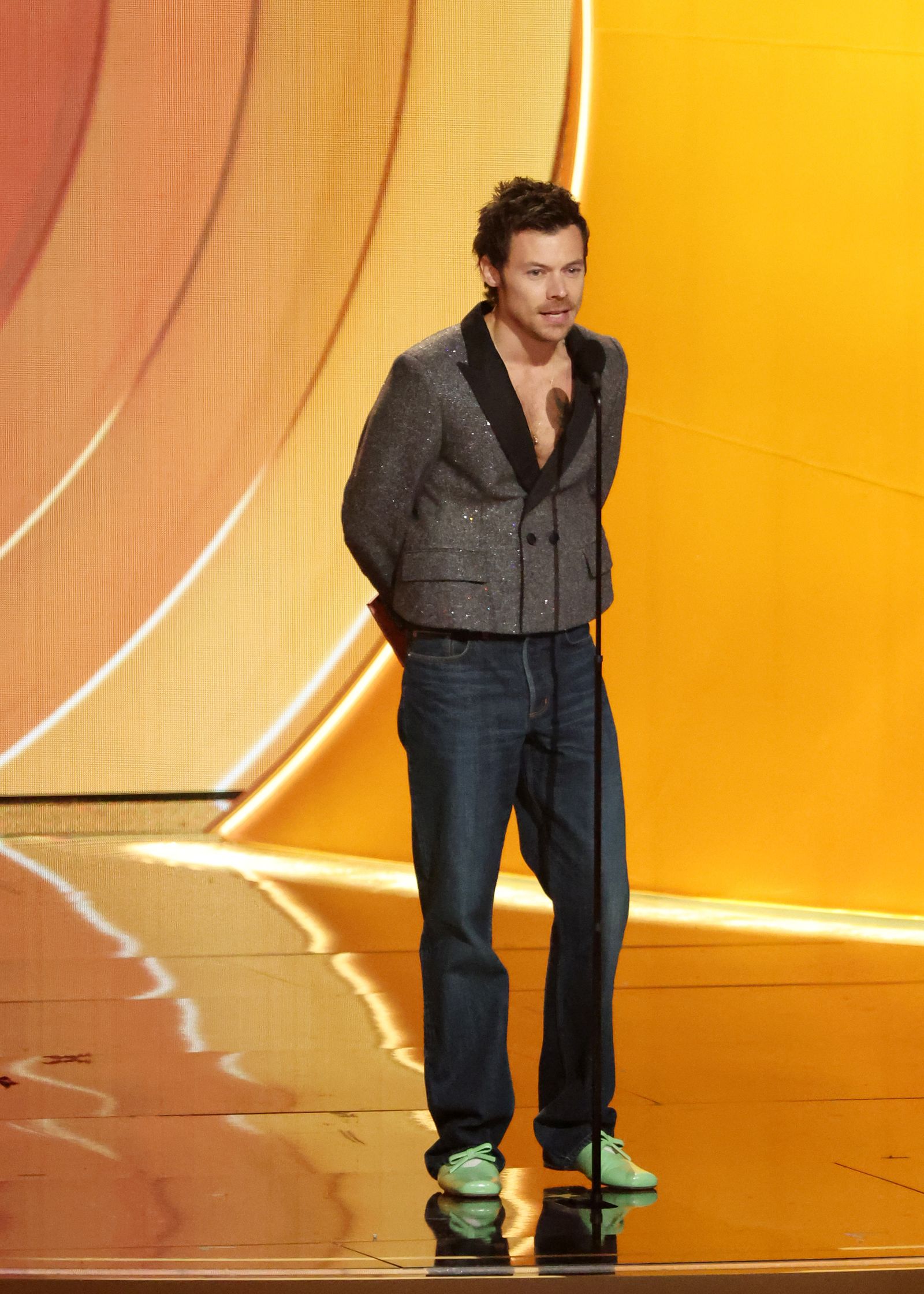 Image may contain Harry Styles clothing pants blazer jacket jacket standing person adults and performers