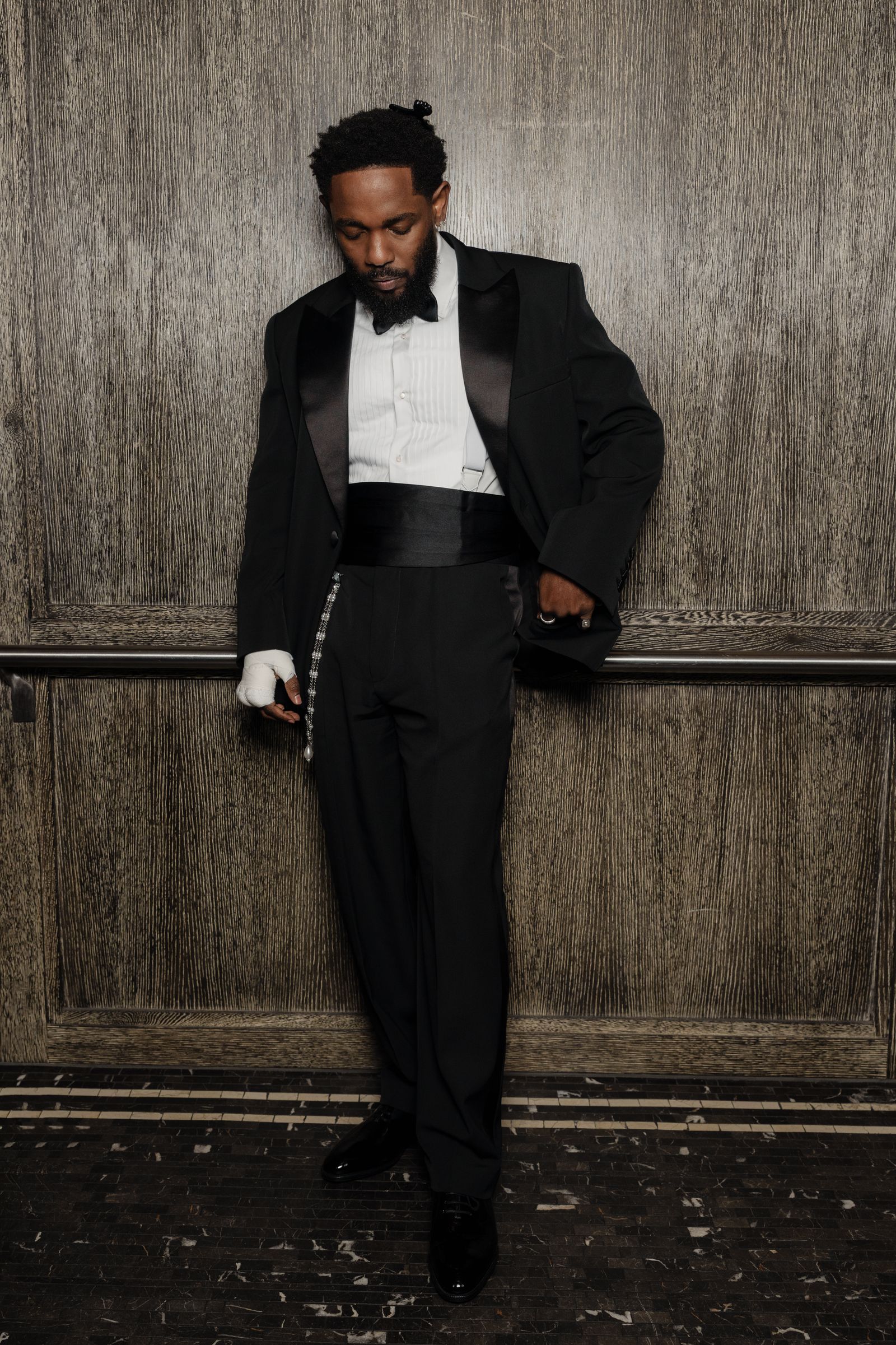 Image may contain Kendrick Lamar Clothing Formal Suit Adult Standing Jacket and Gloves