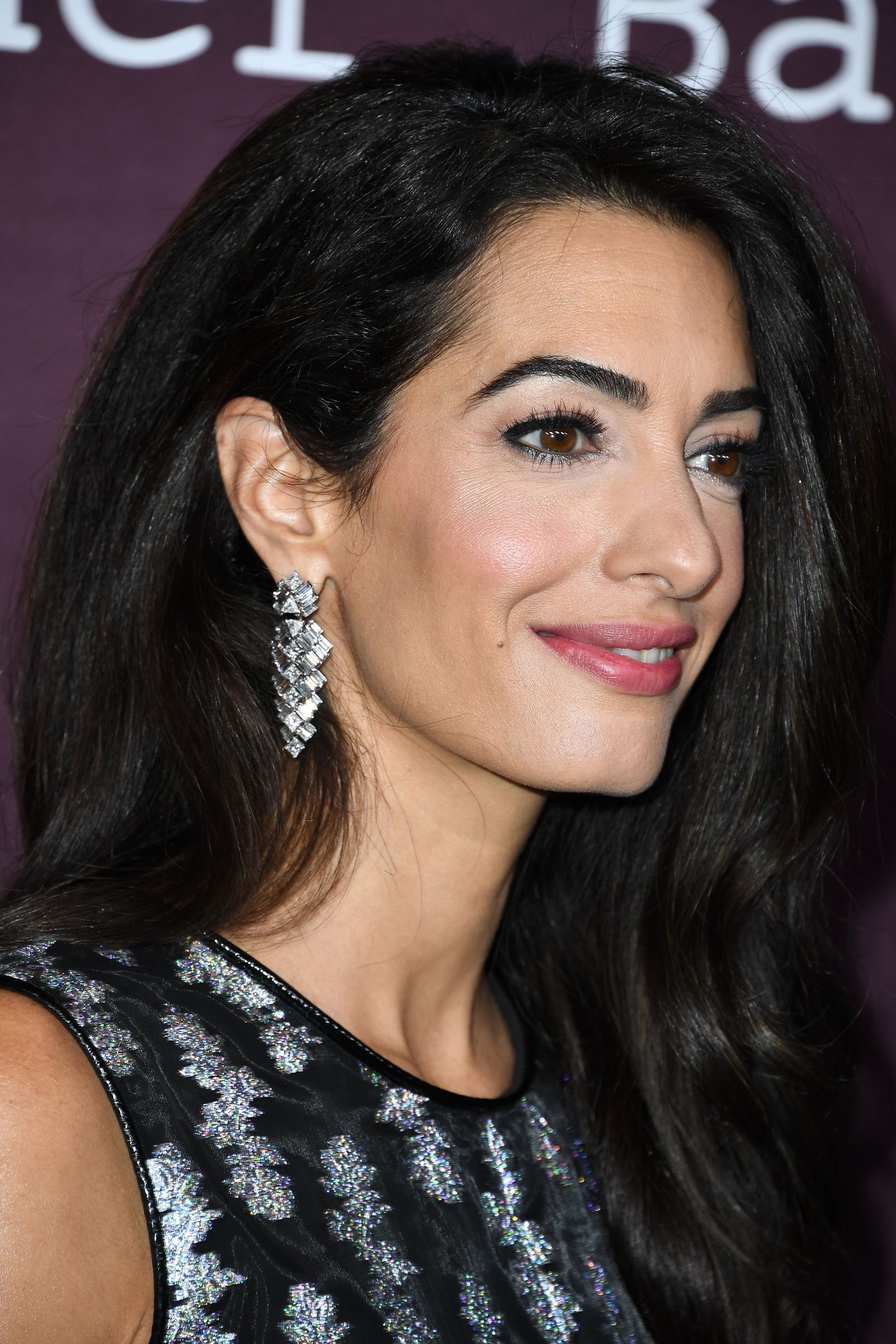 Image may contain Amal Clooney face, hair accessories, jewelry and black hair