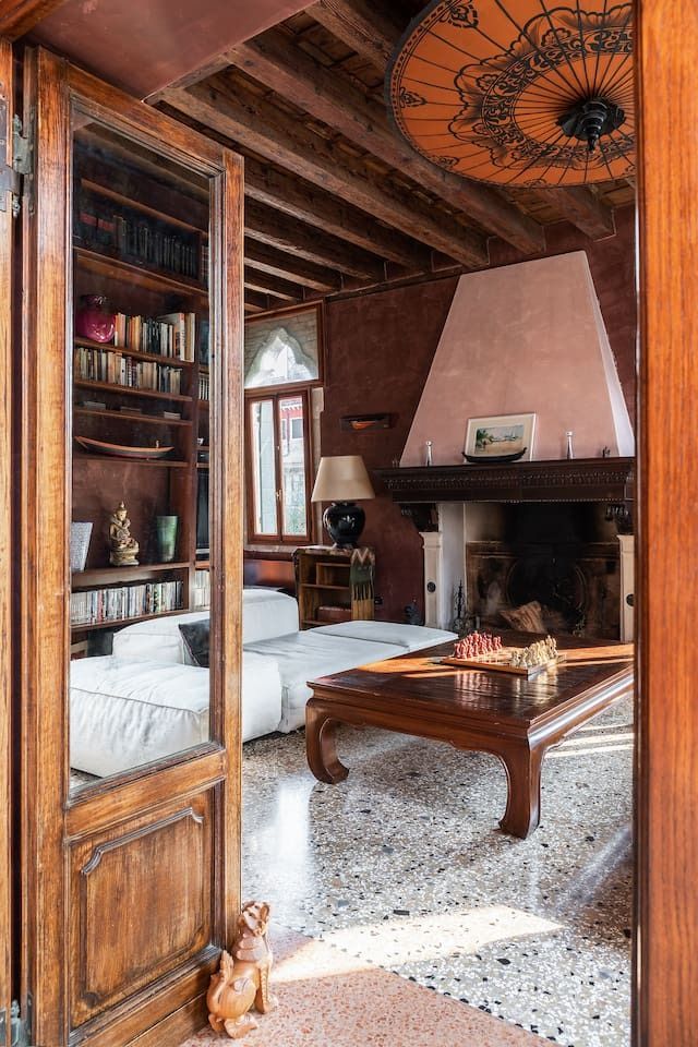 Image may contain interior design, hardwood, stained wood, wood furniture, bed, bedroom, mug and artistic interior lamp