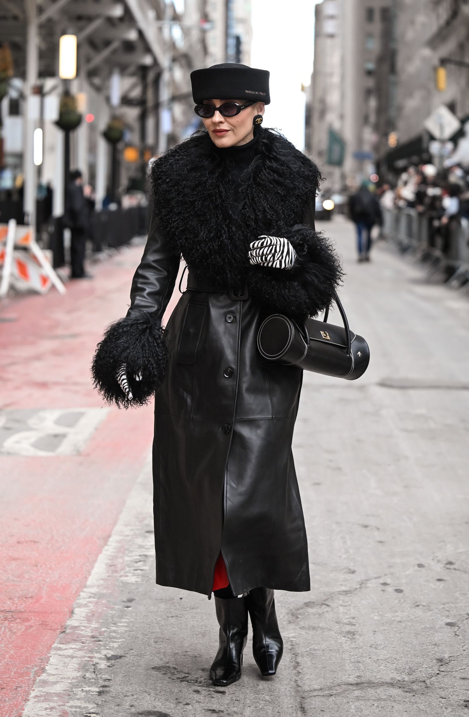 Image may contain clothing, coats, overcoats, people, accessories, bags, handbags, cars, traffic and vehicles