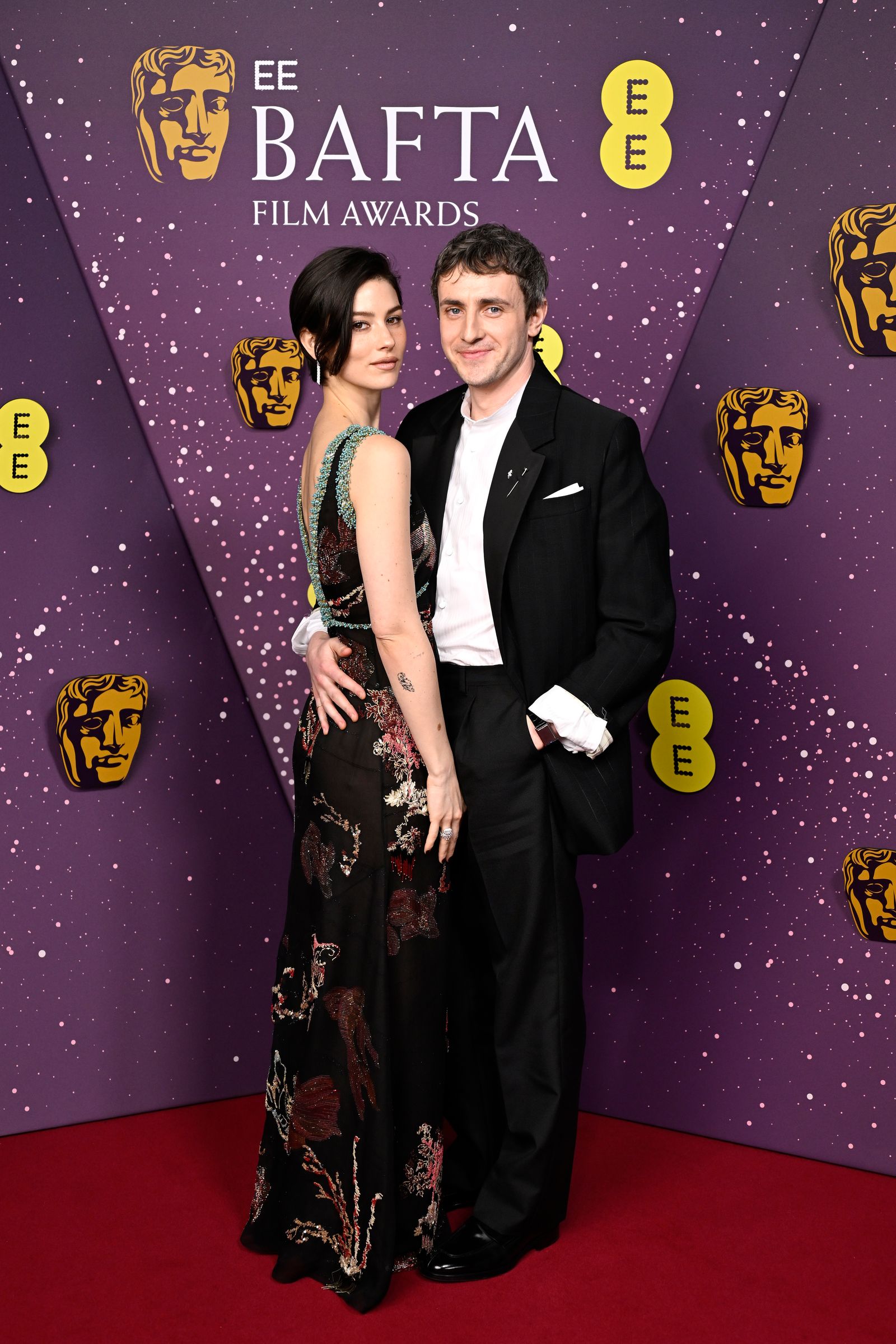 Pictures may contain fashionable adult faces, heads, premiere outfits, formal wear and suits