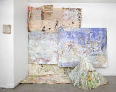 An abstract painting fell from the wall to the floor.