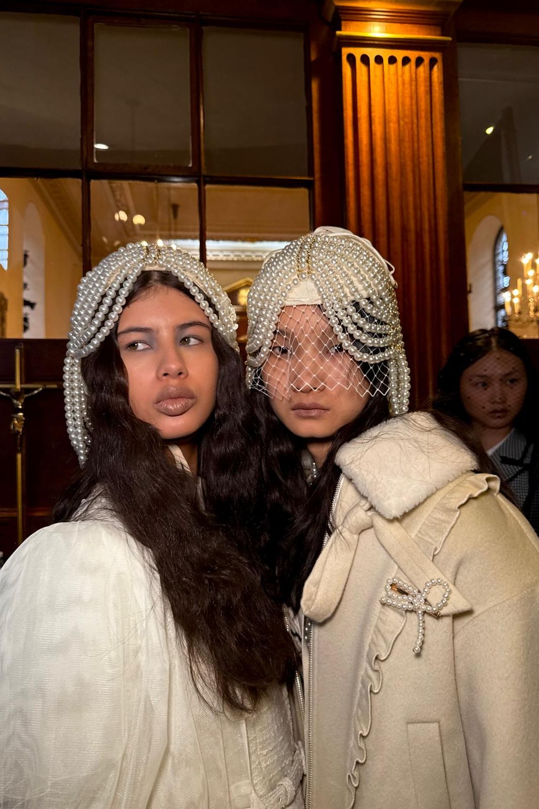 Image may contain people, photobombing of people, adult wedding attire, coats, faces, head photography and portraits