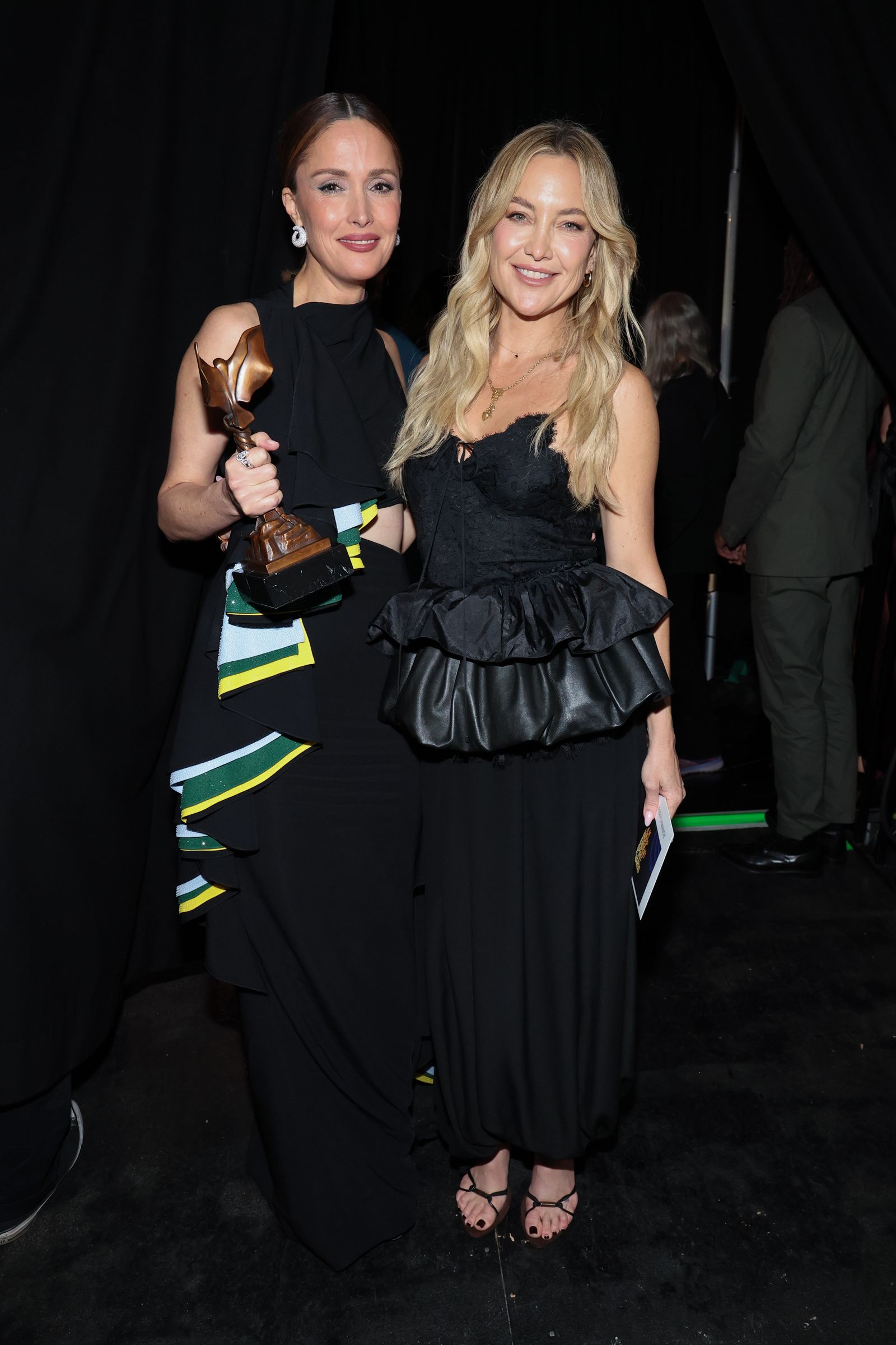 Image may contain Kate Hudson Rose Byrne fashion adult clothing, dresses, photobombs, face and head