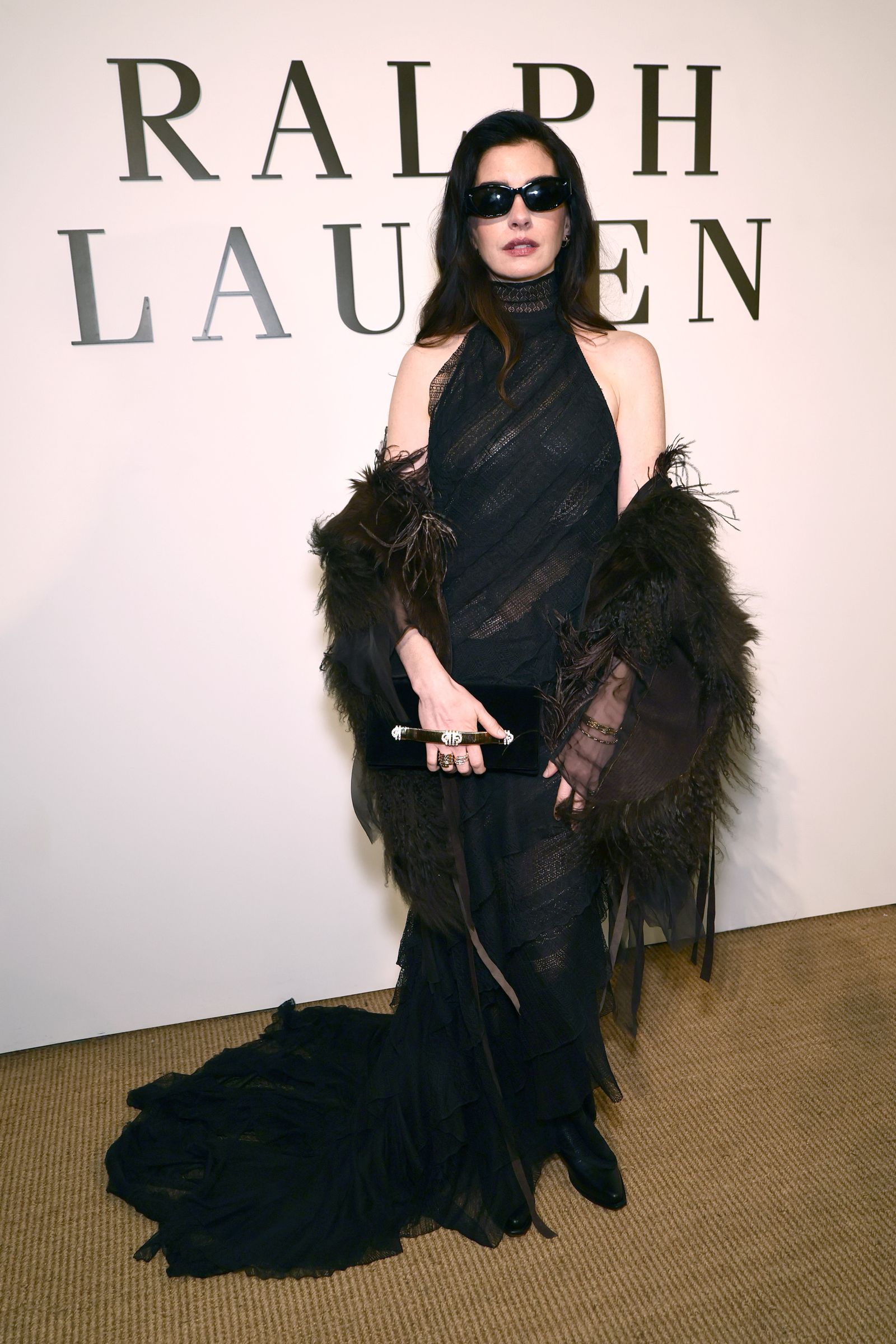 Images may contain Anne Hathaway fashion adult clothing, dresses, formal wear, brunettes, hair and clothing