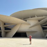 A man stood in a rather wild looking building.