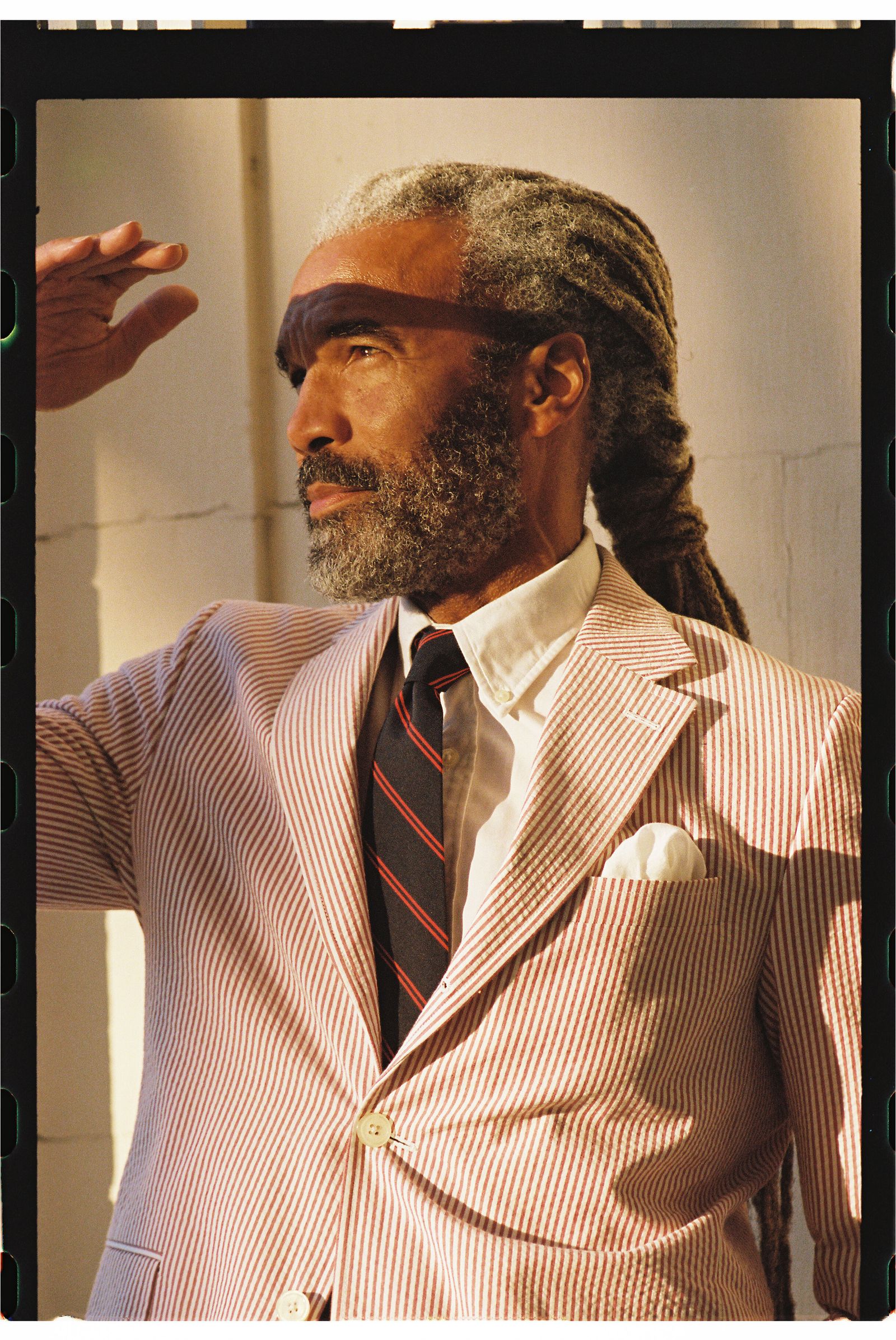 Image may contain accessories formal wear tie face head person photography portrait adult clothing suit and beard