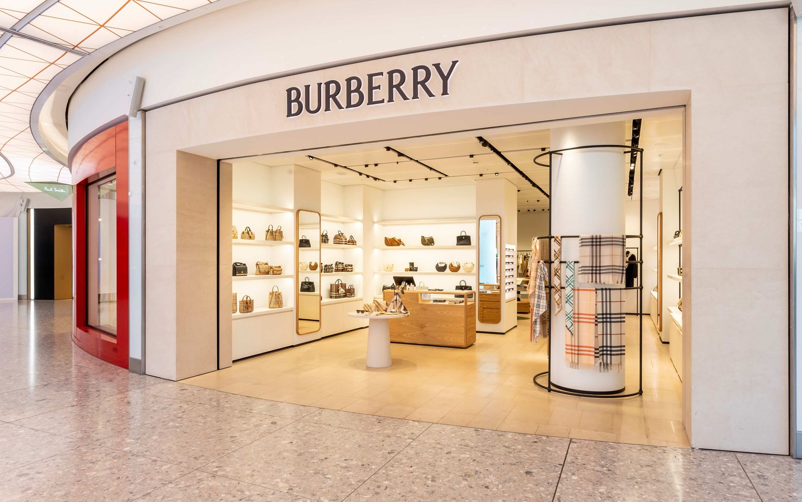 Image may contain store accessories, bags, handbags, shoe store and people