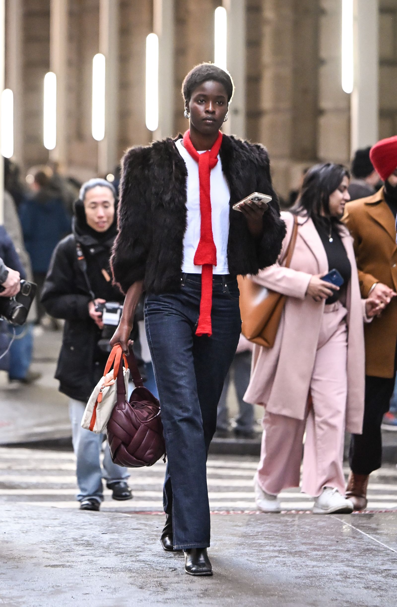 Image may contain people, clothing, pants, adult outerwear, accessories, bags, totes, jackets and blazers