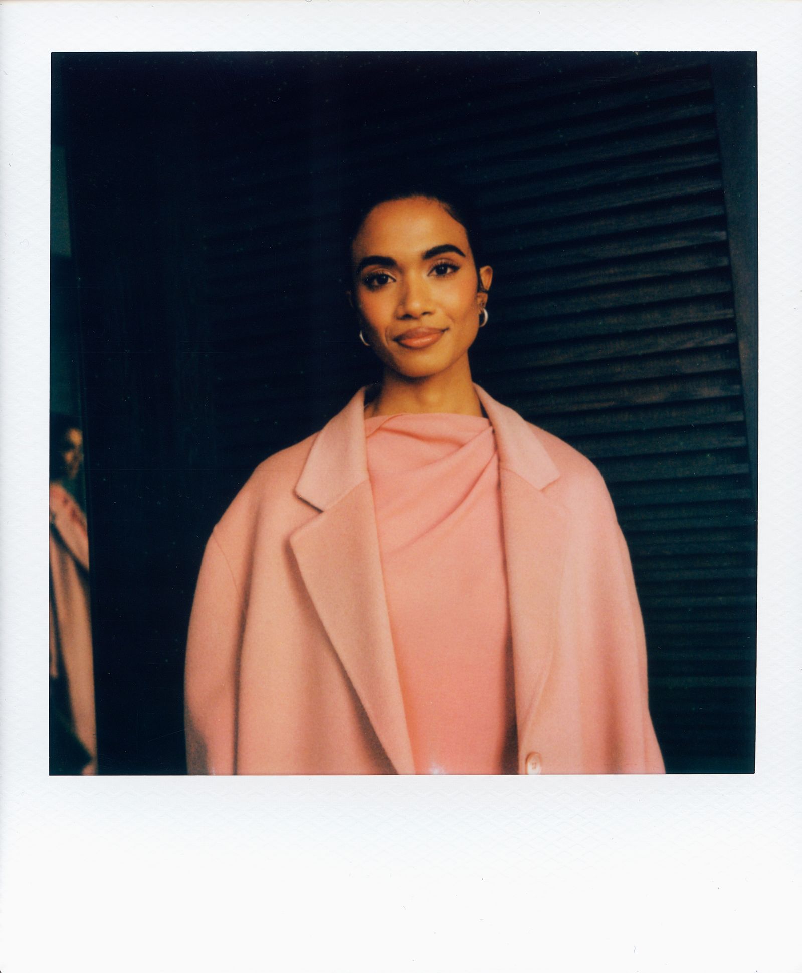 Image may contain face, head, people photography, portrait, clothing, coat, blazer, happy smiling and adults