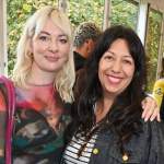 Two women smile for the camera.
