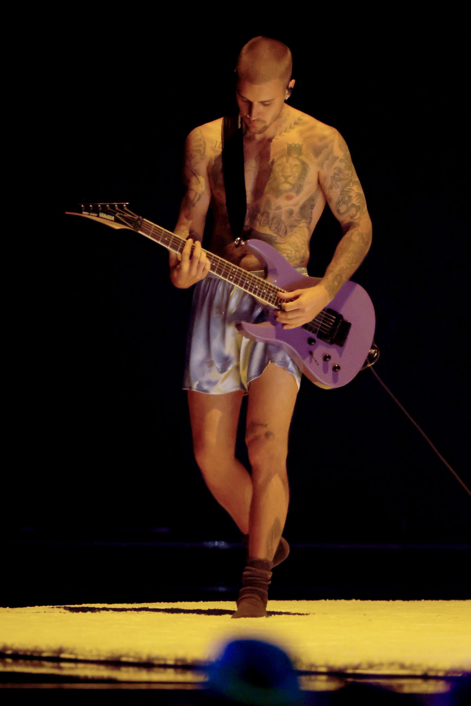Image may contain justin bieber guitar instrument adult performer solo performance and guitarist