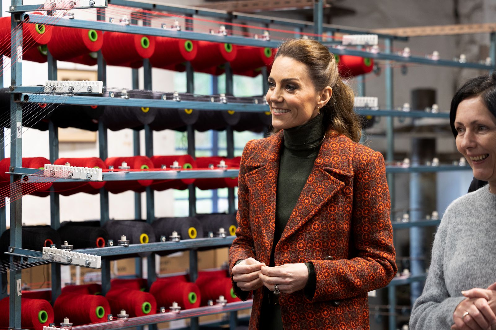 Image may contain face, happy head, people, smile, adult clothing, coat, jacket, blazer and dimples