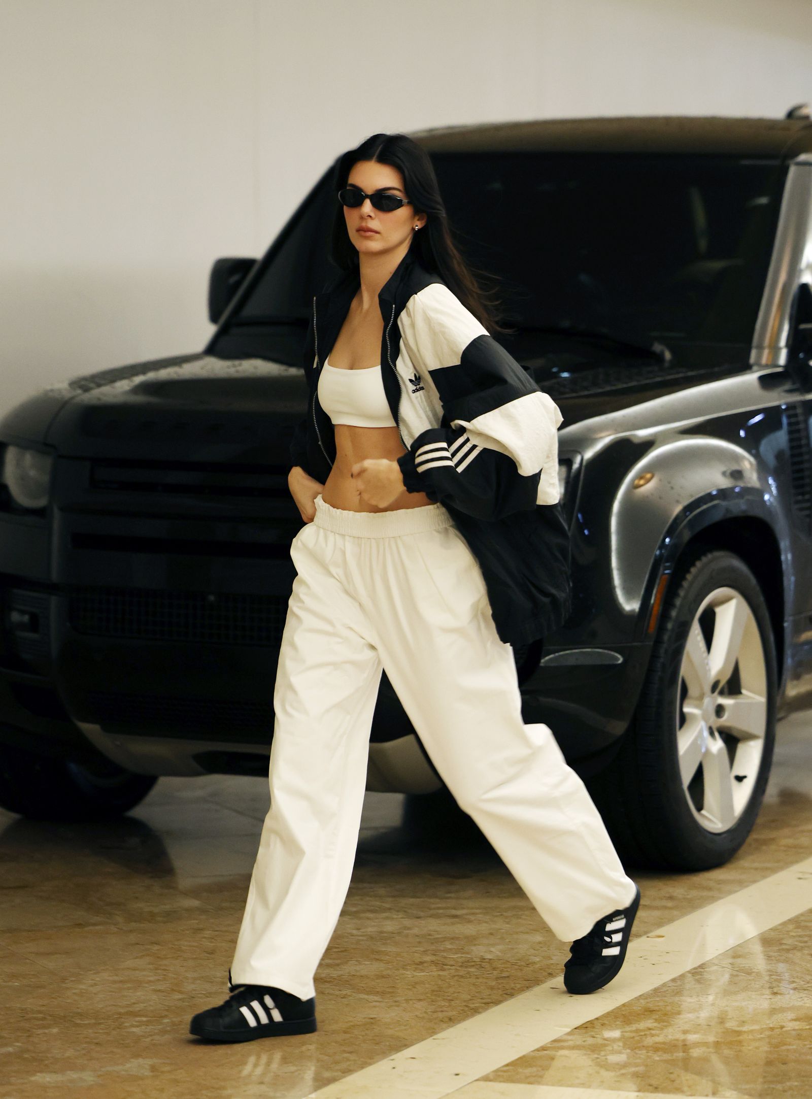 Image may contain Kendall Jenner clothing, pants, shoes, car, transportation, adults and people