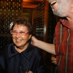A smiling woman wearing red glasses.