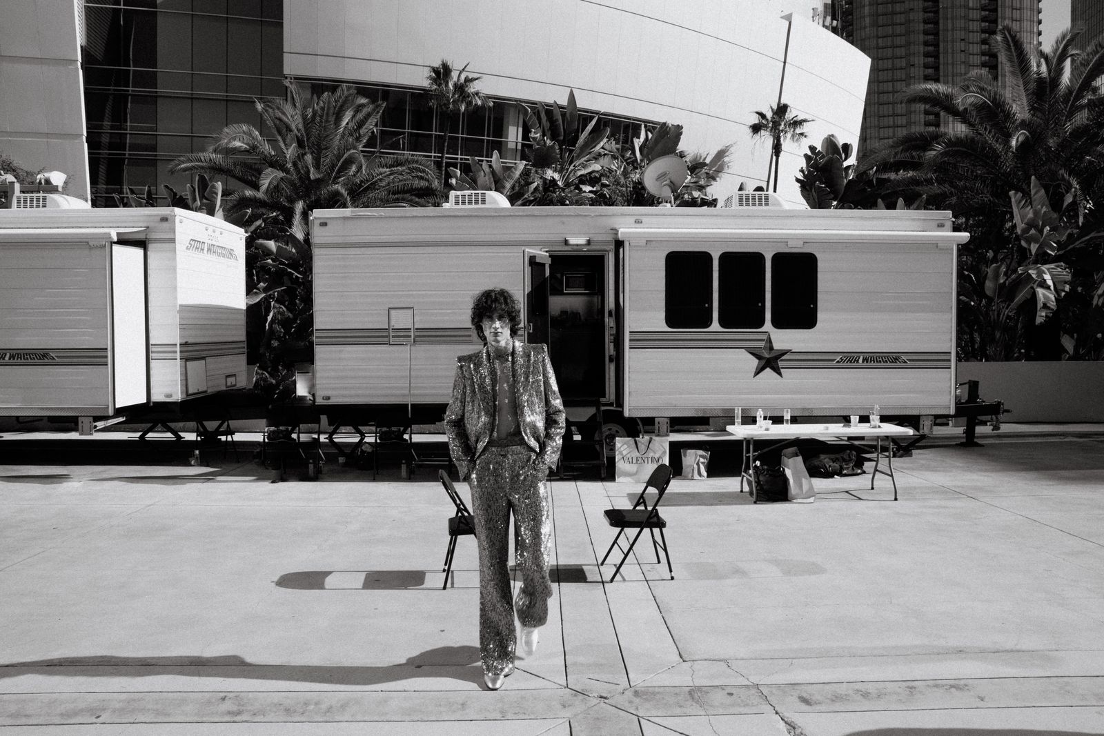 Image may contain palm trees, plants, tree faces, heads, people photography, portraits, chairs, furniture and adults