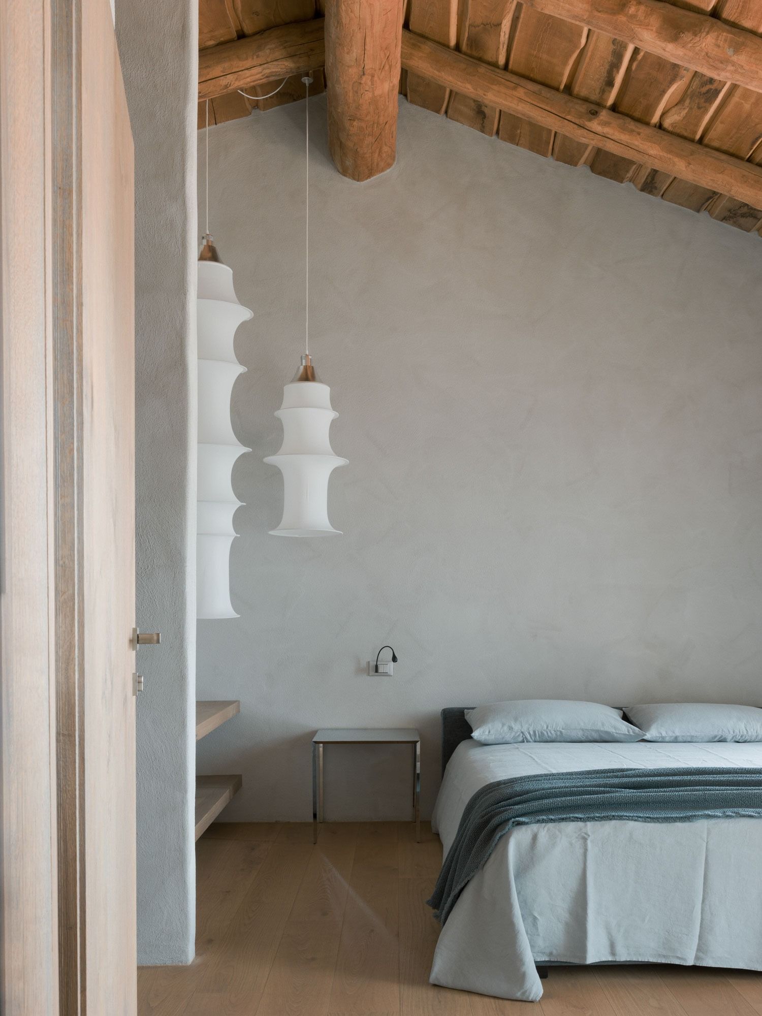 Image may contain interior interior design, bed, furniture, lamp, architecture, house, flooring and home decor