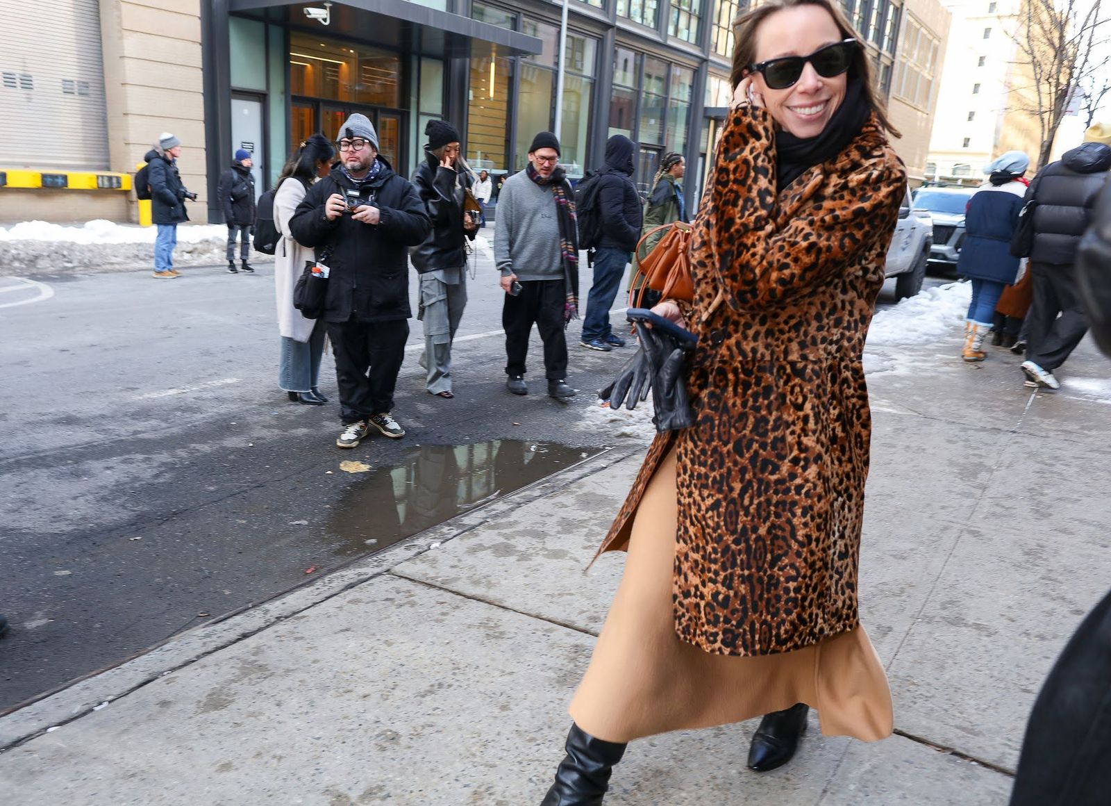 Image may contain clothing, outerwear, adults, urban roads, urban footwear, shoes, accessories, bags and handbags