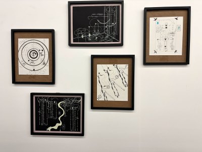There is a set of abstract diagrams on the wall.
