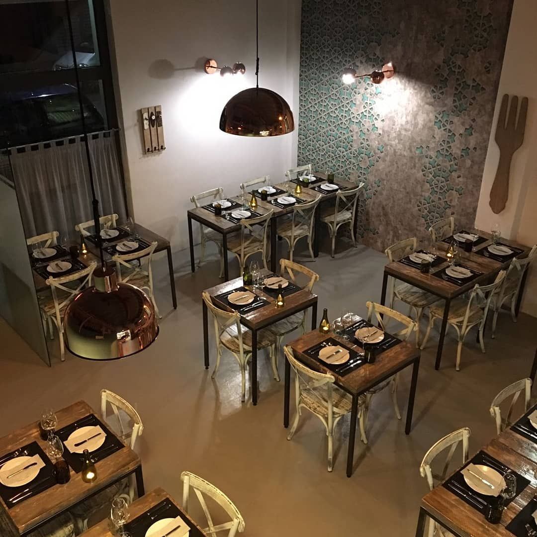 Image may contain furniture, lamp, tabletop, chair, dining table, building, architecture, restaurant and interior