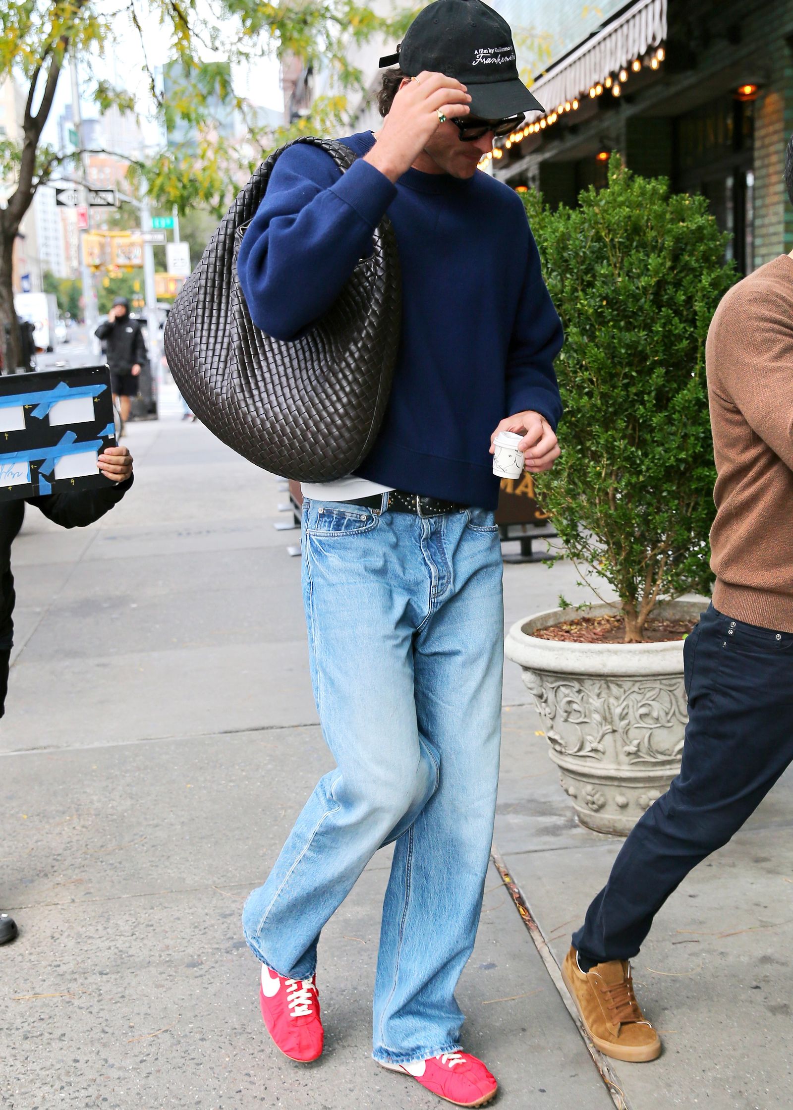 Image may contain clothing, pants, jeans, baseball caps, hats, adult accessories, bags and handbags