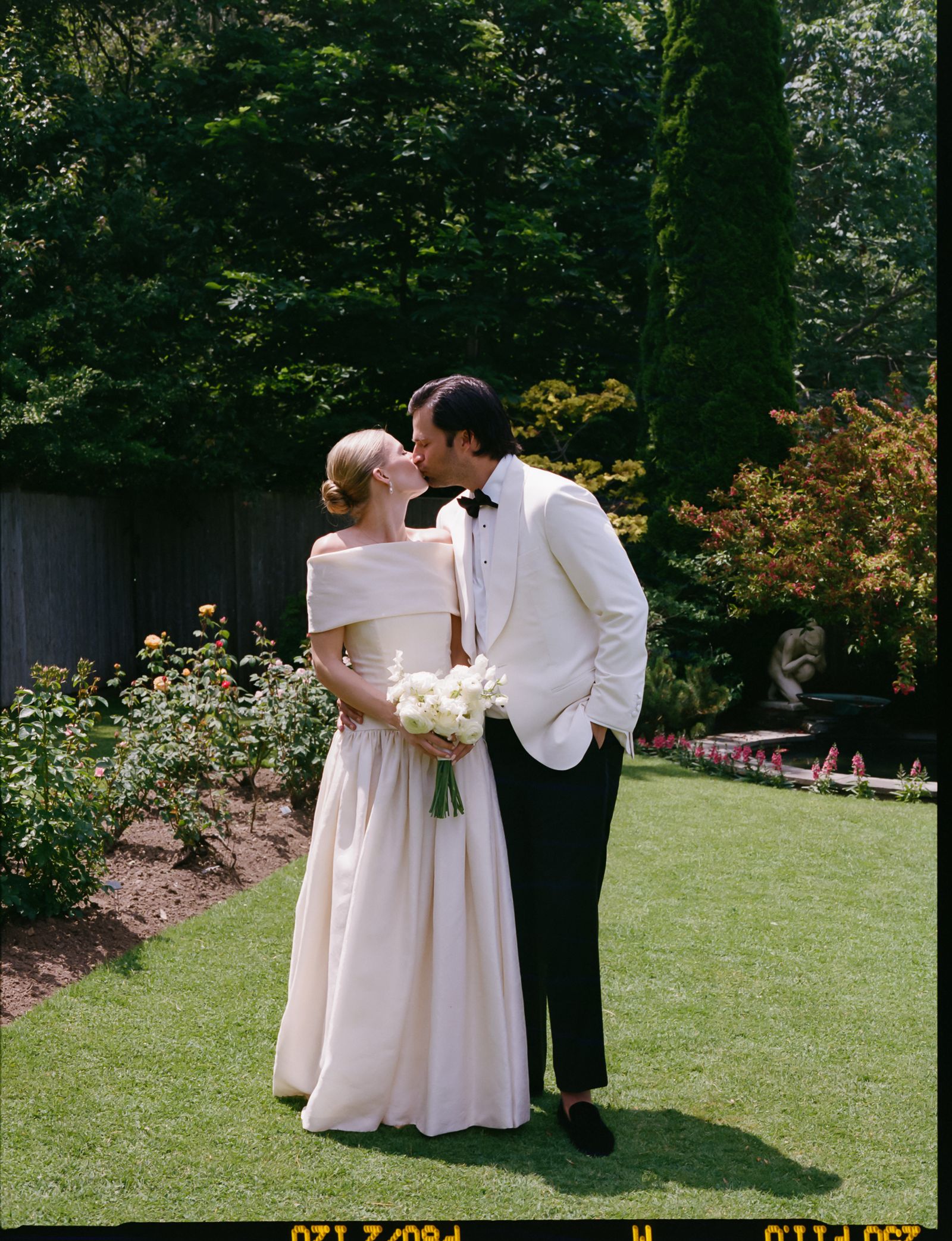 Image may contain grass, plants, photography, faces, heads, portraits, clothing, dresses, fashion, formal wear and gowns