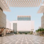 Across the courtyard you see a white building with