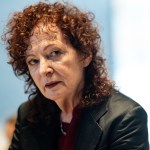 A woman looks at the camera.