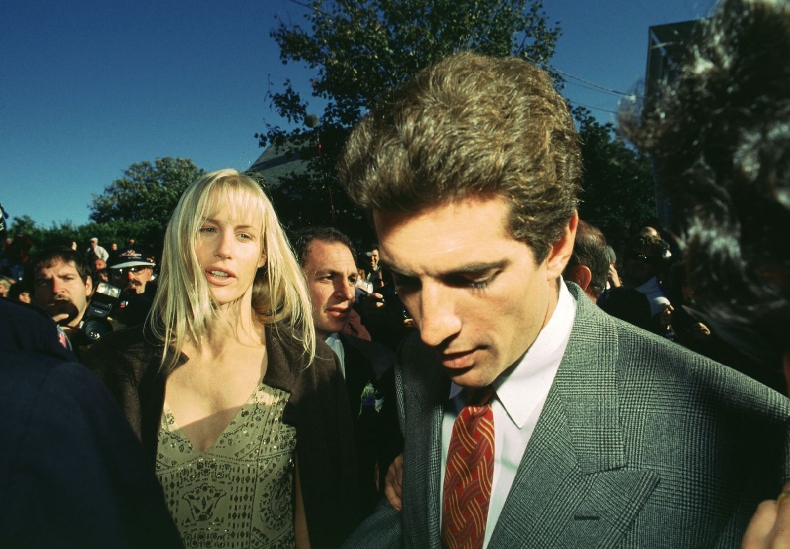 Image may contain John F. Kennedy Jr. Daryl Hannah Akiva Goldsman clothing formal suit accessories tie and face